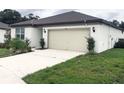 This property has a two car garage and well-kept landscaping at 1050 Michelangelo Ln, Winter Haven, FL 33884