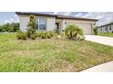 Well-maintained lawn and landscaped front yard adds curb appeal to this cozy home at 1050 Michelangelo Ln, Winter Haven, FL 33884