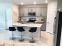 Modern kitchen with a stylish island, stainless steel appliances, and sleek countertops at 1050 Michelangelo Ln, Winter Haven, FL 33884