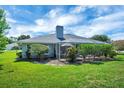 Large private backyard featuring green lawn and screened lanai at 109 Lake Mariam Way, Winter Haven, FL 33884