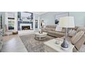 Bright living room with fireplace, tile floors, and beach-themed decor at 109 Lake Mariam Way, Winter Haven, FL 33884