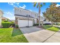 Charming home featuring a basketball hoop, a two-car garage, and a lush green lawn at 110 Minniehaha Cir, Haines City, FL 33844
