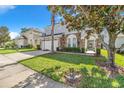 Attractive house with a well-maintained lawn, two-car garage, and stone accents at 110 Minniehaha Cir, Haines City, FL 33844