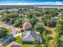 An aerial view shows the layout of a quiet residential neighborhood near a lake at 123 Evergreen Dr, Auburndale, FL 33823