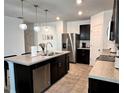 Spacious kitchen with an island, stainless steel appliances, and ample counter space at 1363 Benevento Dr, Winter Haven, FL 33884