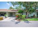 Exterior view of home featuring mature trees and colorful flowerbeds highlighting its curb appeal at 2202 Starboard, Winter Haven, FL 33881
