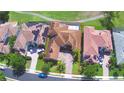 Birds eye view of a single Gathering home with tile roof, showcasing the neighborhood and driveway at 2340 Pinehurst Ct, Davenport, FL 33837