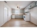 Bright kitchen featuring updated appliances, light-colored cabinets and hardwood flooring at 2409 E Civitan Ave, Lakeland, FL 33801