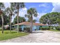 Charming single-story home with a well-manicured lawn, palm trees, and an inviting driveway at 255 Lake Link Rd, Winter Haven, FL 33884