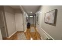 Hallway with decorative wall trim, hard wood floors, leading to the front door and various rooms at 3828 Eloise Estates Ct, Winter Haven, FL 33881