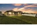 Large, green backyard featuring a screened-in patio for outdoor living and entertaining at 428 Aragosa Dr, Davenport, FL 33837