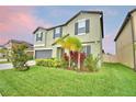 Charming two-story home with a well-maintained lawn, garden and two-car garage at 4400 Trotters Way, Lakeland, FL 33801