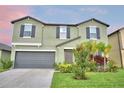 Charming two-story home with a well-maintained lawn and a two-car garage at 4400 Trotters Way, Lakeland, FL 33801