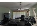 Inviting living room featuring plush seating, a ceiling fan, and ample natural light at 4488 Turnberry Ln, Lake Wales, FL 33859