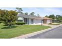 Charming single-story home with brick driveway and lush green front lawn at 469 Sweetwater Way, Haines City, FL 33844