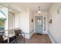 Welcoming front porch with brick flooring and seating area at 469 Sweetwater Way, Haines City, FL 33844