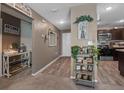Inviting hallway with laminate flooring, decorative accents, and views into the kitchen and living areas at 47 Willow Ln, Kissimmee, FL 34759