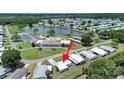 Aerial view of a blue home near a lake, pool, and community center at 4859 Foxwood Blvd, Lakeland, FL 33810