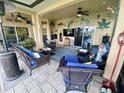 Cozy covered patio with ceiling fans, comfortable seating, and stylish decor perfect for outdoor relaxation and entertainment at 5005 Pebble Beach Blvd, Winter Haven, FL 33884