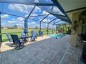 Screened-in lanai featuring a pool with ample seating for entertaining and enjoying outdoor living at 5005 Pebble Beach Blvd, Winter Haven, FL 33884