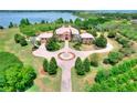 Majestic lakefront estate with circular driveway, mature trees, lush lawn and lovely landscaping at 501 Adams Barn Rd, Auburndale, FL 33823