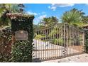Elegant wrought iron gate with lush landscaping welcomes you to Casa Bella at 501 Adams Barn Rd, Auburndale, FL 33823