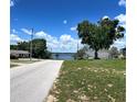 Scenic street view leading to a lake, showcasing the desirable neighborhood and natural beauty at 504 W 7Th St, Frostproof, FL 33843