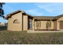 Inviting single-story home with a neatly landscaped front yard and a blue front door at 505 8Th S St, Dundee, FL 33838