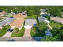 An aerial view of a single-Gathering home featuring a well-maintained yard and brick driveway at 560 Saint Andrews Rd, Winter Haven, FL 33884