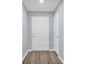Clean and bright entryway with wood-look flooring and white doors at 648 Lorient Dr, Eagle Lake, FL 33839