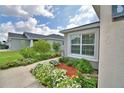 Charming house with fresh exterior paint, neat flower beds, and a paved walkway at 879 Orleans Dr, Eagle Lake, FL 33839