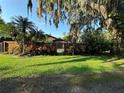 The beautiful front yard is adorned with lush landscaping and a privacy fence at 9402 Cat Track Trl, Lake Wales, FL 33898