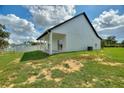 Spacious backyard featuring a manicured lawn, a large, covered patio, and serene views at 1042 Golden Bough Rd, Lake Wales, FL 33898