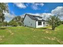A single Gathering home with a pristine lawn, featuring a clean, minimalist design at 1042 Golden Bough Rd, Lake Wales, FL 33898