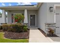 Inviting front entrance with a well-manicured yard and attractive stone pillar accents at 1081 Sandpiper Loop, Winter Haven, FL 33881