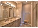 Bathroom featuring double sinks, granite countertops, and a shower at 1100 Sugarwood St, Davenport, FL 33837