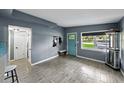 Open living space with gray walls, wood-look tile floors, and an inviting front entrance with a pop of color at 1140 W Seminole Trl, Bartow, FL 33830