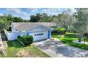 Inviting single-story home with attached two-car garage and beautifully landscaped front yard at 118 Browning Cir, Winter Haven, FL 33884