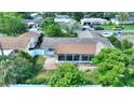 Aerial view of the home's rear with screened in porch, fenced yard, and mature trees at 118 Browning Cir, Winter Haven, FL 33884