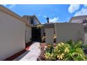 Welcoming townhome entrance with tiled walkway, lush plants, and decorative lighting at 12241 Augusta Woods Cir, Orlando, FL 32824