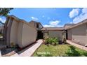 Charming townhome with a walkway leading to the entrance and beautifully manicured front yard at 12241 Augusta Woods Cir, Orlando, FL 32824