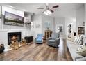 Cozy living room with a fireplace, hardwood floors, and comfortable seating at 125 Homewood Dr, Winter Haven, FL 33880