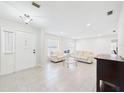 Bright living room featuring neutral paint, tile floors, and lots of natural light at 14191 Se 25Th Ave, Summerfield, FL 34491
