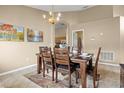 Lovely dining room with neutral walls, stylish lighting, and a beautiful dining set at 151 Hideaway Beach Ln, Kissimmee, FL 34746