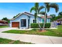 Charming single-story home with lush lawn and two palm trees enhancing curb appeal at 1553 Wright Dr, Lakeland, FL 33805