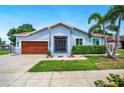 Inviting single-story home with manicured lawn and wrought iron security gate at 1553 Wright Dr, Lakeland, FL 33805