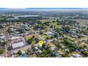 Aerial shot shows the home's location within a quiet neighborhood, near local amenities and a picturesque lake at 165 E Pierce St, Lake Alfred, FL 33850