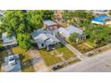 Aerial view showcasing the property's layout, including the detached garage, and its neighborhood setting at 165 E Pierce St, Lake Alfred, FL 33850