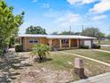 Inviting single-story house with a covered porch, well-manicured landscaping, and a cozy residential charm at 1929 4Th Ne St, Winter Haven, FL 33881