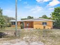 Single-story home with a spacious backyard and a partially covered patio, ideal for relaxation and outdoor activities at 1929 4Th Ne St, Winter Haven, FL 33881
